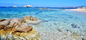 brown rocks on blue sea under blue sky during daytime